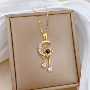Luxurious gold-plated crescent moon pendant necklace with tassel drops and stones