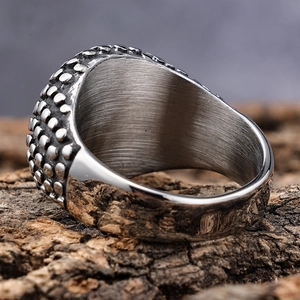 Vintage silver punk ring with studded dot texture on rustic bark background
