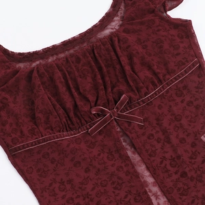 Detail of square neckline with lace mesh and velvet bow on burgundy summer top
