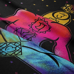 Macro shot of colorful chakra symbols and star patterns on a soft bohemian wall tapestry