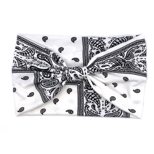 Detail of bohemian paisley print stretch cotton headband with a knotted bow design