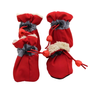 Detailed view of red waterproof dog boots with reflective straps and warm white fur lining