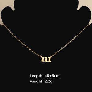 Golden stainless steel angel number 111 necklace shown on a black mannequin bust