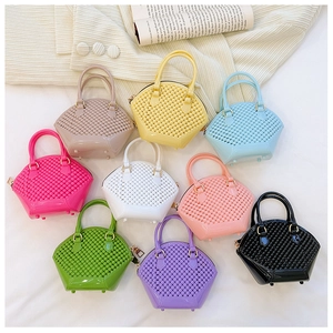 Flat lay of nine colorful mini jelly handbags with quilted texture and gold hardware