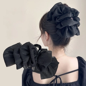Large black mesh bow shark hair claw clip shown on a model for a chic and stylish look