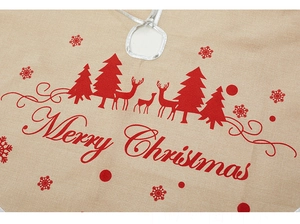 Detail of linen Christmas tree skirt with reindeer pattern and Merry Christmas print