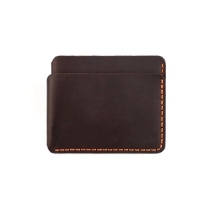 Detail of dark brown leather card holder with prominent orange hand-stitched seams