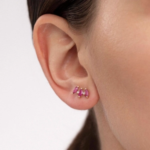 Detail of S925 silver stud earring with marquise pink zircons on a model ear