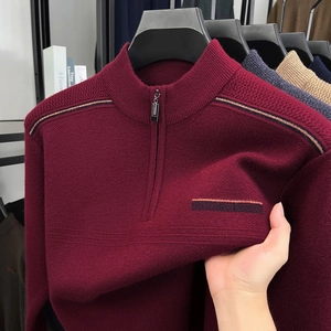 Detail of red men's half-zip knit sweater showing elastic fabric texture and stripes