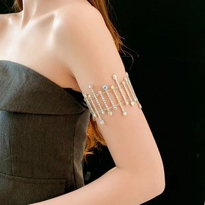 Macro view of sparkling silver-tone arm cuff with rhinestones on model's arm