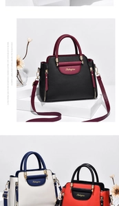 Detail of lychee pattern leather handbag with adjustable strap and golden logo