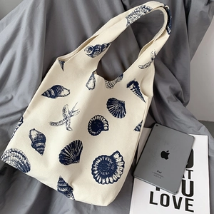 Detail of canvas tote bag with starfish print and large capacity for students