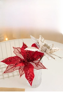 Close-up of sparkling sequined artificial Christmas flowers in red and champagne gold colors