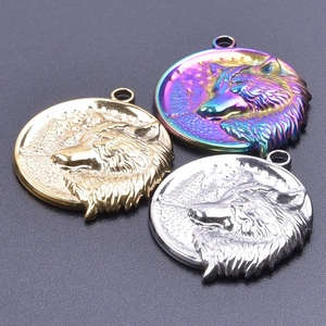 Three punk style wolf head pendant charms in gold, silver, and rainbow stainless steel