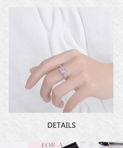 Macro shot of princess cut pink zircon stone with pave setting diamonds on silver band