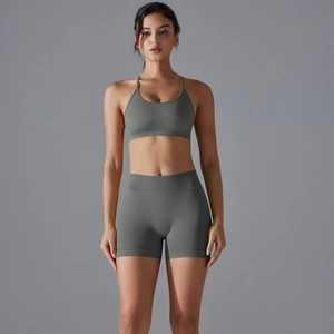 Front view of a dark grey-green seamless knitted yoga set with sports bra and shorts