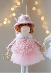 Detail of pink plush Christmas angel doll ornament with mesh skirt and golden stars