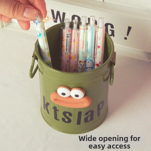 Detailed view of wide opening iron pen holder with hand reaching for a cartoon pen