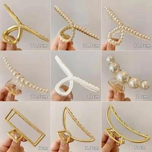 Detail showcasing various sizes of elegant gold, pearl, and matte claw hair clips