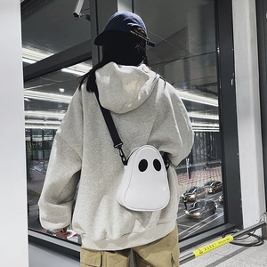 Ghost-shaped PU leather crossbody bag featuring iconic black eyes on white surface