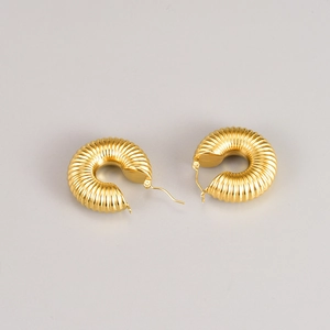 Golden chunky hoop earrings with vertical ribbed design and hollow vintage aesthetic