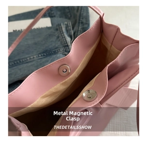 Detailed view of pink tote bag showing interior silver magnetic snap closures and PU texture