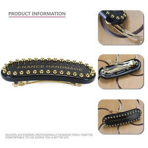 Elegant black and gold acetate hair clip with pearl trim and France handmade logo