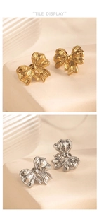 Detailed close-up of bow knot earrings in gold and silver finish with textured patterns