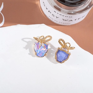 Detail of leopard head pendant with iridescent crystal and gold bow for DIY jewelry making