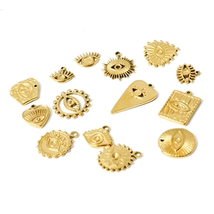 Set of 18k gold plated evil eye charms and pendants in various shapes on white background
