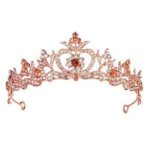 Close-up of rose gold baroque crown with orange crystals and white rhinestones