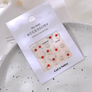 Nail art decoration set with red rhinestones and silver frames on white display card