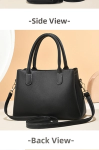 Detail view of black lychee leather handbag showing side and back with gold hardware