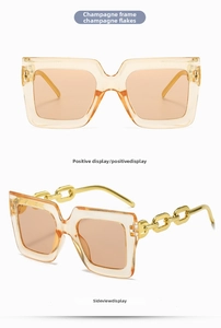 Macro view of champagne square sunglasses with metallic chain-link temple detail