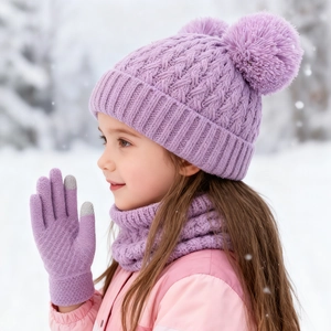 Detail of purple knitted winter set featuring double pom pom hat and touchscreen gloves