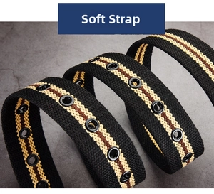 Detail of soft black canvas belt with yellow stripes and metallic eyelets on grey surface