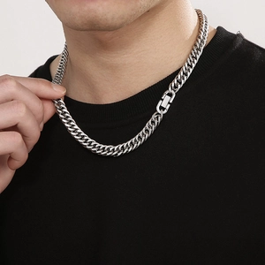 Close-up of men's silver curb chain necklace with a square buckle clasp on a model