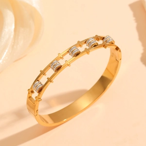 Close-up of double-layered gold titanium bracelet with sparkling white zircon stones