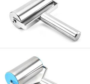 Close-up of stainless steel rolling pins with metal and blue plastic handle details