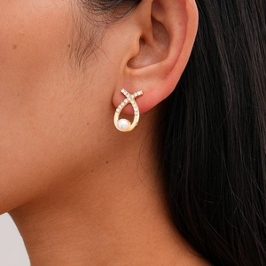 Detail showing the elegant pearl flower earring with sparkling crystals on a female model