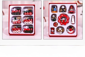 Detailed view of red and green painted wooden Christmas train and angel ornaments in a box
