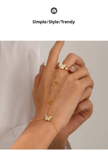 Detail of 18K gold plated hand harness featuring white butterfly shell inlays for women