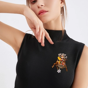 Christmas reindeer brooch with colorful enamel and rhinestones on a black turtleneck