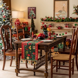 Christmas table runner with green jacquard pattern and tassels on festive dining table