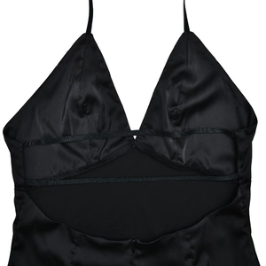 Detail of elegant black satin backless dress with deep V neckline and cutout straps