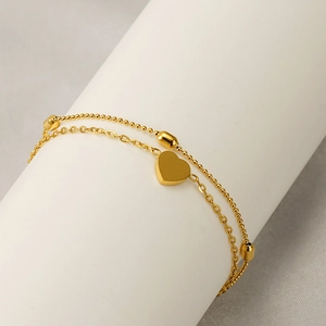 Double-layered 18K gold plated steel anklet featuring heart charms and oval beads