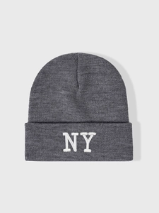 Close-up of high-quality white NY letter embroidery on dark grey knitted beanie