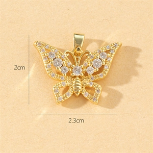 Macro shot of gold butterfly pendant with crystals showing 2cm by 2.3cm dimensions