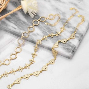 Close-up of gold-plated butterfly and heart bracelets with micro-pave cubic zirconia