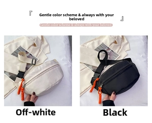 Detail of canvas chest bags in beige and black with vibrant orange zipper pull cords